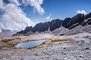 Rugged Terrain Prints: Dramatic rugged mountain range with a lake
