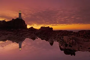 Images Dated 2nd January 2000: Dramatic sunset and low tide, Corbiere lighthouse, St. Ouens, Jersey, Channel Islands