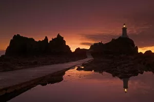 Channel Islands Collection: Dramatic sunset, low tide, Corbiere lighthouse, St. Ouens, Jersey, Channel Islands