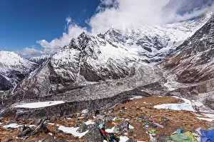 Glacial Prints: Dramatic view of Langtang Lirung glacier beneath towering Himalayan peaks and prayer flags from Kyanjin Ri