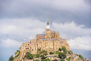 Pilgrimage Prints: Dramatic view of Mont Saint-Michel Abbey rising above the village in Normandy France
