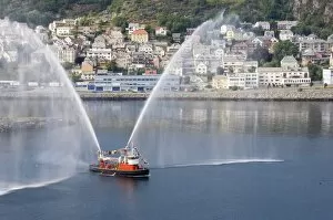 Dressed overall, with the traditional farewell display, the fireboat at Alesund