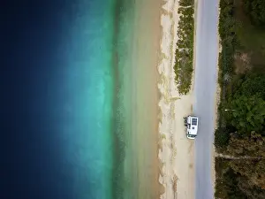 Azure Prints: Drone top aerial view of camper van parked on a wild beach in Porto Koufo