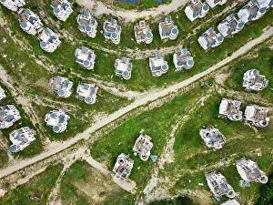 Drone Prints: Drone view of abandoned fairy tale castles in a ghost town in Turkey with overgrown land and winding paths