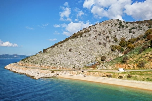 Drive Prints: Drone view of camper van on a mountain road on the coast, Greece