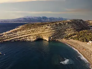 Artificial Prints: Drone view of Matala artificial caves on the rock by the beach at Crete