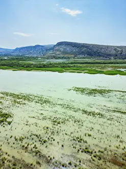 Wetlands Prints: Drone view reveals Nallihan Bird Sanctuary with diverse wetlands and distant hills in Ankara