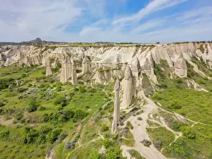 Love Prints: Drone view shows rock formations in Love Valley with green landscape in Cappadocia