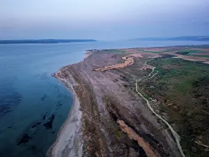 Uninhabited Prints: Drone view of Sigeion cape at sunset in Cannakale Turkey showing land and water blending in the distance