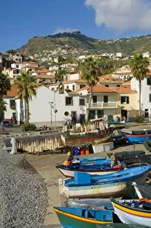Drying salt cod (bacalhau) and fishing boats in the small south coast harbour of Camara de Lobos