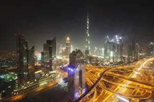 Downtown Prints: Dubai skyline and Sheikh Zayed Road Interchange by night, Dubai, United Arab Emirates
