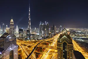 Dubai skyline and Sheikh Zayed Road Interchange by night, Dubai, United Arab Emirates