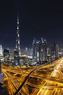 Dubai skyline and Sheikh Zayed Road Interchange by night, Dubai, United Arab Emirates