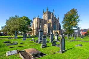 Cemetery Prints: Dunfermline Abbey with gravestones under blue sky in Dunfermline, Fife, Scotland