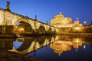 Dusk on the ancient palace of Castel Sant Angelo with statues of angels on the bridge