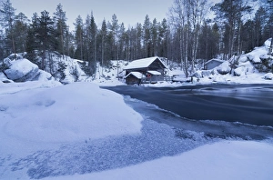 Wooden Hut Prints: Dusk frames the frozen water in the snowy woods and a wooden hut, Juuma, Myllykoski