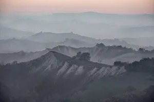Dusk over hills where many layers are covered by fog, Emilia Romagna, Italy, Europe
