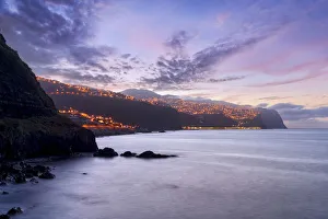 Dusk over the illuminated coastal village of Ponta do Sol, Madeira island, Portugal