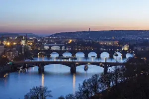 Motion Blur Prints: Dusk lights up the historical bridges and buildings reflected on Vltava River, Prague