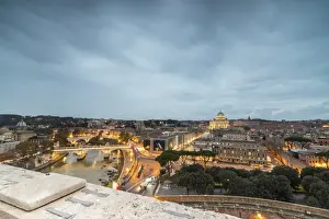 Vatican Prints: Dusk lights on Lungo Tevere with the Basilica di San Pietro in the background, Rome