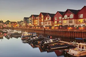 Apartments Prints: Dusk view of the harbour with boats and apartments in Exmouth, Devon, United Kingdom