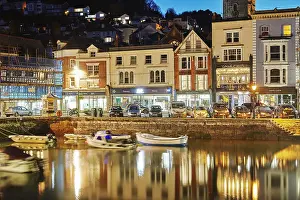 A dusk view of historic buildings around the old harbour at Dartmouth, in the mouth of the River Dart, on the south coast of Devon, England, United Kingdom, Europe