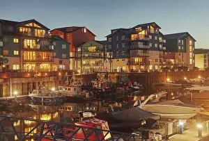 Apartments Prints: Dusk view shows boats and apartments around the harbour at Exmouth in Devon on the coast of Great Britain