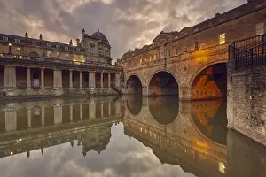 A dusk view of the unique 18th century Pulteney Bridge spanning the River Avon