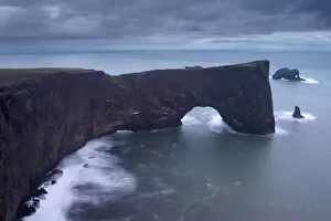 Dyrholaey natural arch, southernmost point in Iceland, at dusk, near Vik