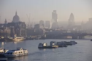 Early morning fog over the City of London skyline, London, England, United Kingdom