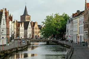 Sidewalk Prints: Early morning light on traditional buildings in old town, Bruges, Belgium