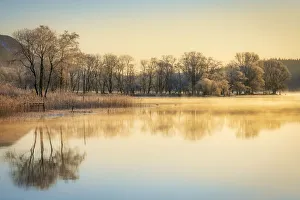Early morning mist clearing and sunlight over Loch Ard, Kinlochard, Aberfoyle, Scotland