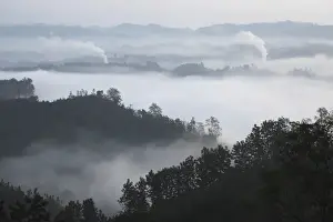 Early morning mist and smoke from brickworks in the valley over the jungle of Bandarban, Chittagong Division, Bangladesh, Asia