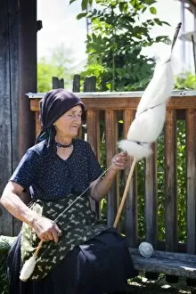 Elderly woman spinning wool, Ieud, Maramures, Romania, Europe
