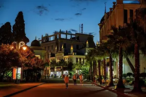Fresh Prints: Elegant buildings light up the Ocean promenade at night in Sukhumi