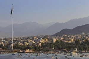 Hazy Prints: Elevated view of Aqaba seafront with huge Jordanian flag