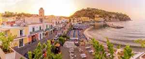 Sandy Beach Prints: Elevated view of beach and the town of Lacco Ameno at sunset