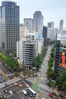 Road Markings Prints: Elevated view of a busy city centre street and high rise buildings on a rainy summer day