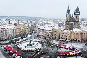 Spires Prints: Elevated view of the Church of Our Lady Before Tyn and Christmas markets at Old Town Square in winter