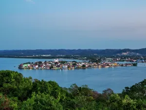Lakeside Prints: Elevated view of Flores Island at dusk with water and hills in the background in Peten Department