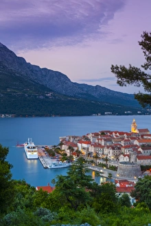 Elevated view over Korculas picturesque Stari Grad (Old Town) illuminated at dusk, Korcula Town, Korcula, Dalmatia, Croatia, Europe Elevated view over Korculas picturesque Stari Grad (Old Town) illuminated at dusk, Korcula Town, Korcula, Dalmatia, Croatia, Europe