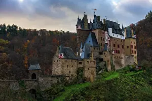 Castle Walls Prints: Eltz medieval historic castle in an autumn landscape with trees at sunrise