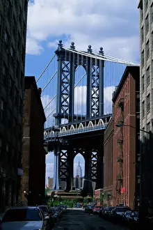 Empire State Building in distance seen through Manhattan Bridge