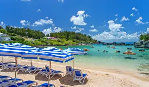 Time Prints: Enjoying a sunny day at Tobacco Bay with beach chairs and umbrellas in Bermuda's clear waters