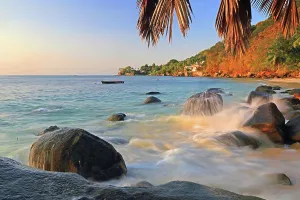 Warmth Prints: Enjoying the waves and scenery at Beau Vallon beach during sunset in Seychelles