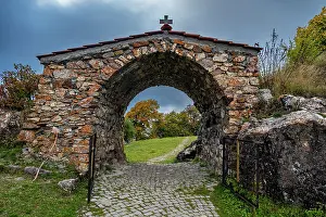 Gate Prints: Entrance gate leading to St. George Church in South Ossetia showcasing stone structure and pathway