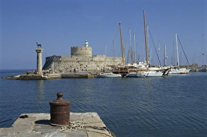 Rhode Prints: The entrance to Mandraki Harbour, with one of the buck statues and St