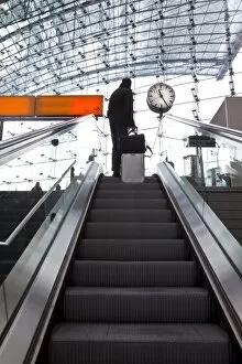 Escalator and platform clock at modern train station, Berlin, Germany, Europe