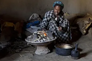 Ethiopia Prints: Ethiopian woman setting fire to boil the water for coffee for traditional ceremony