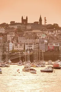 Channel Prints: Evening light casts a warm glow over St. Peter Port harbor and old town in Guernsey